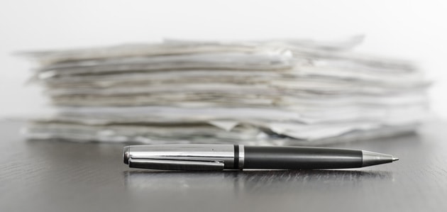 Contracts on a table with a pen., Arrangement Contracts Can Be Similar to a Restraining Order