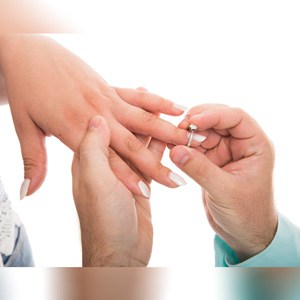 Close up of man putting engagement ring on girlfriend's finger.Who Gets the Engagement Ring in a Breakup?