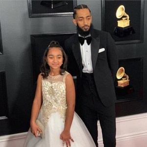 Nipsey Hussle with his daughter, Emani, at the 2019 Grammys in formal wear