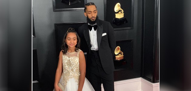 Nipsey Hussle with his daughter, Emani, at the 2019 Grammys in formal wear