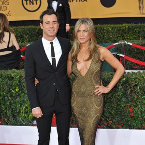 Justin Theroux and Jennifer Aniston pose on the red carpet at the 2015 Screen Actors Guild Awards at the Shrine Auditorium.