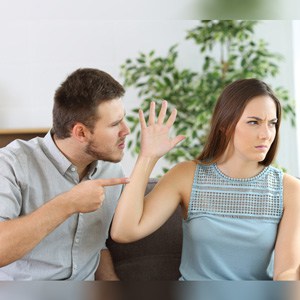 Man and woman arguing in a living room