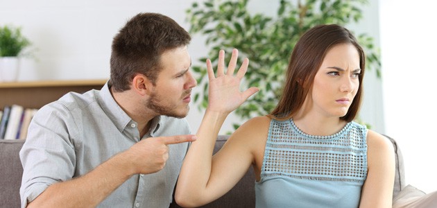 Man and woman arguing in a living room