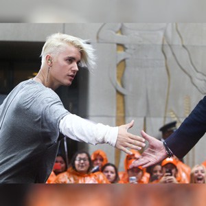 Justin Bieber at a concert shaking hands