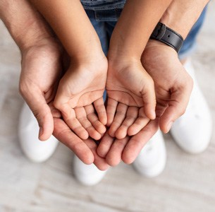 Dads hands with child's hands indicating paternity