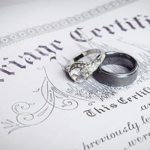 Marriage certificate with wedding rings on it