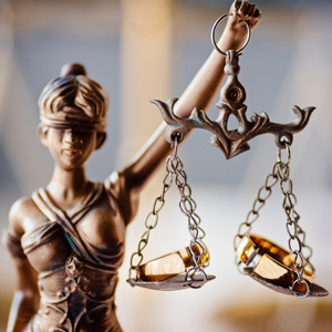 gold lady justice holding up scales