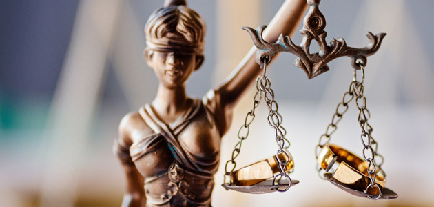gold lady justice holding up scales