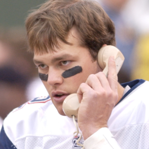 Tom Brady on the phone at a New England Patriots Game
