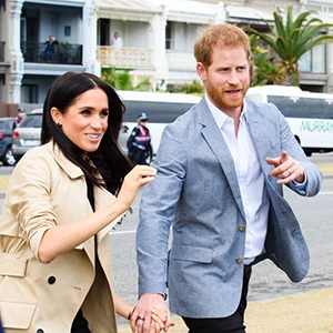 Prince Harry and Meghan Markle walking with urgency.