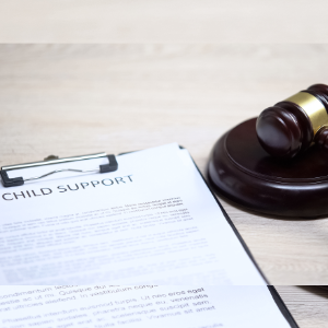 A clipboard with legal papers that say child support next to a gavel