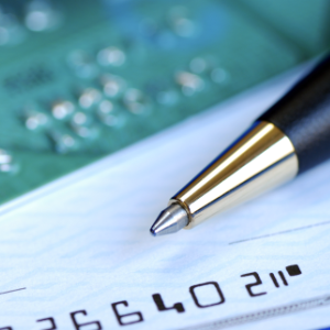 A credit card, pen and check depicting residuals in entertainment contracts